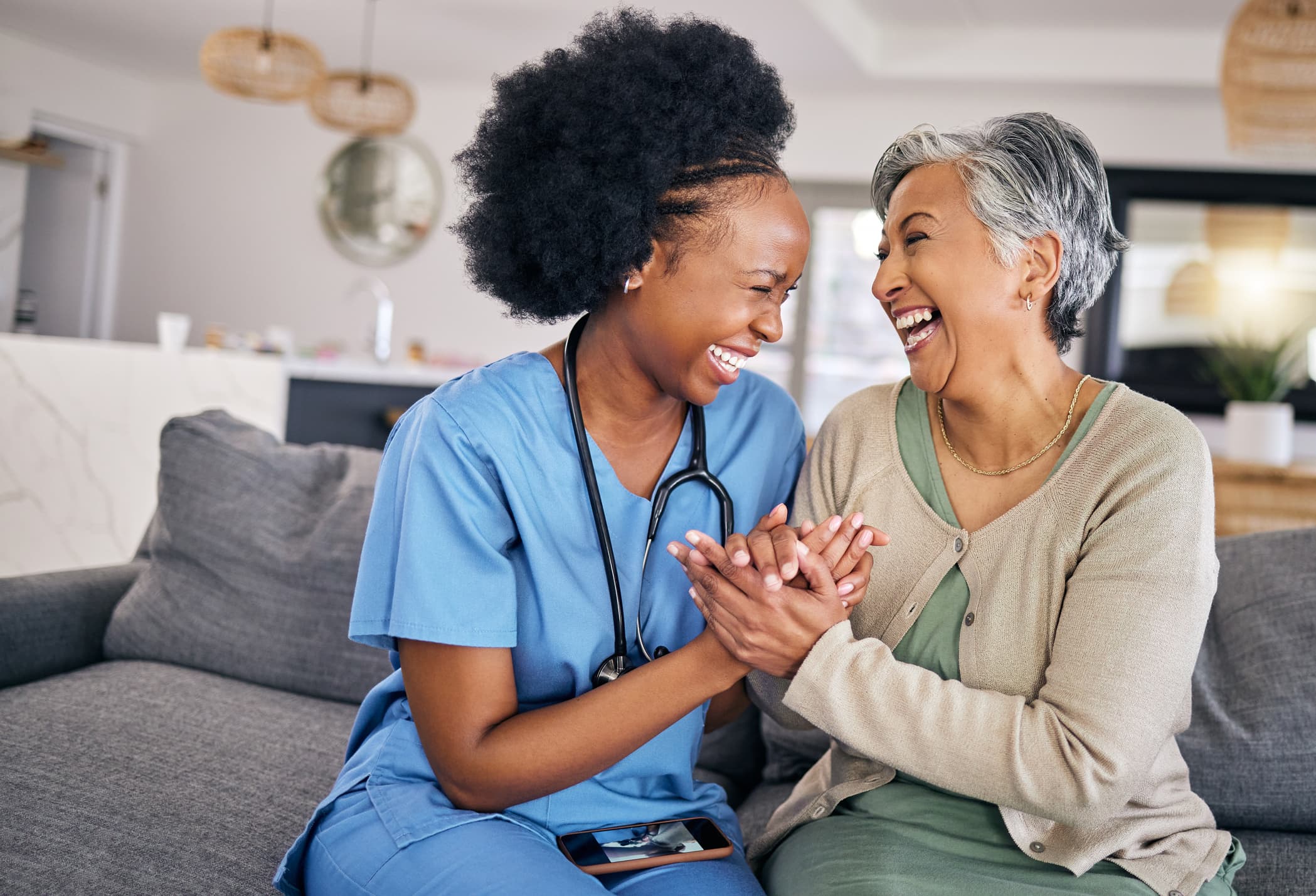 Compassionate caregiver with senior client at home